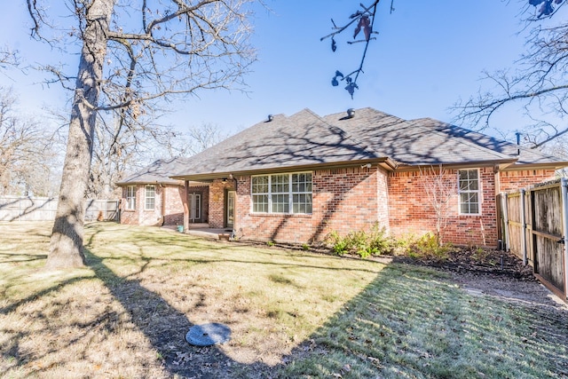 rear view of house with a yard