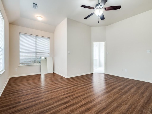 unfurnished room featuring vaulted ceiling, ceiling fan, and dark hardwood / wood-style floors