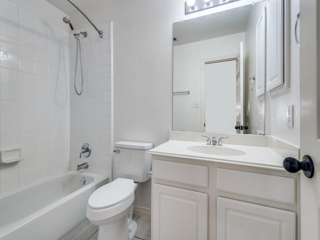 full bathroom featuring tile patterned floors, vanity, tiled shower / bath combo, and toilet