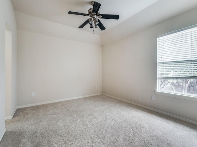 carpeted empty room with ceiling fan and lofted ceiling