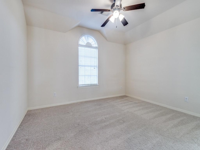 carpeted spare room with ceiling fan and lofted ceiling