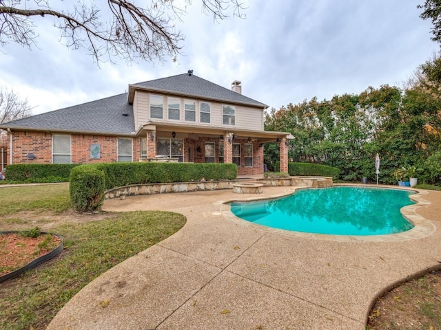 view of swimming pool with a yard and a patio