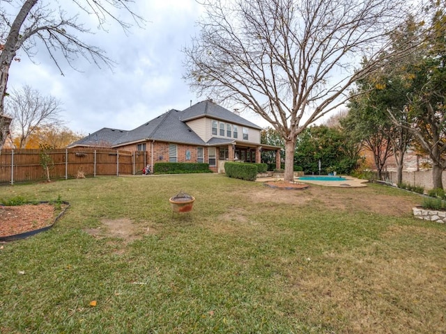 view of yard with a fenced in pool