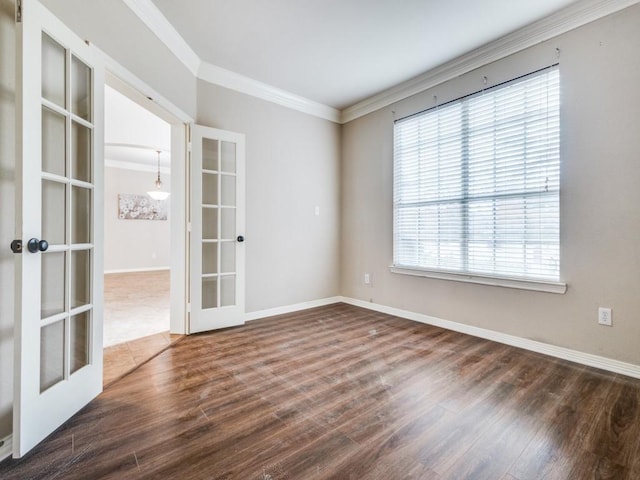 unfurnished room with french doors, dark hardwood / wood-style flooring, ornamental molding, and a healthy amount of sunlight