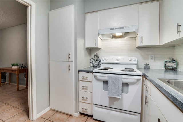 kitchen with white range with electric cooktop, sink, light tile patterned floors, tasteful backsplash, and white cabinetry