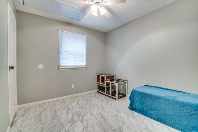 bedroom featuring a textured ceiling and ceiling fan