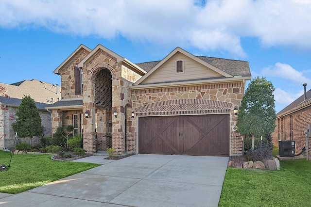 view of front of home featuring a front lawn, central AC unit, and a garage