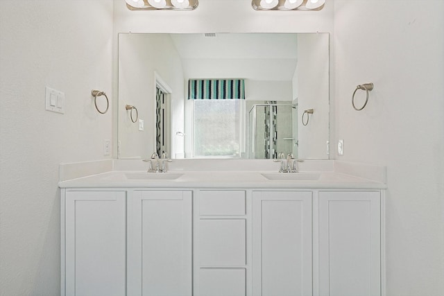 bathroom featuring vanity and an enclosed shower