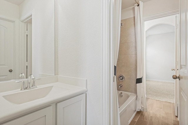 bathroom featuring shower / bath combo and vanity