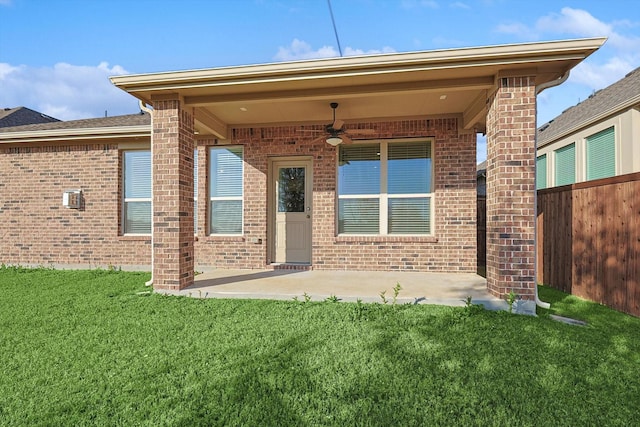 back of property featuring a lawn, ceiling fan, and a patio