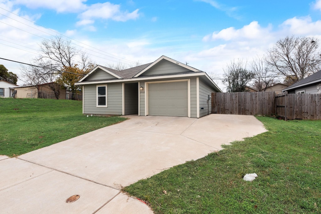 ranch-style house with a garage and a front yard