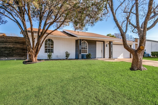 single story home with a garage and a front yard