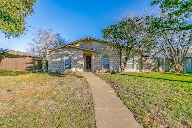 single story home featuring a front lawn