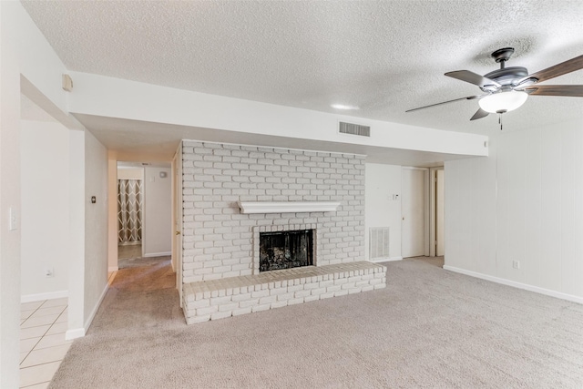 unfurnished living room with a fireplace, light carpet, a textured ceiling, and ceiling fan