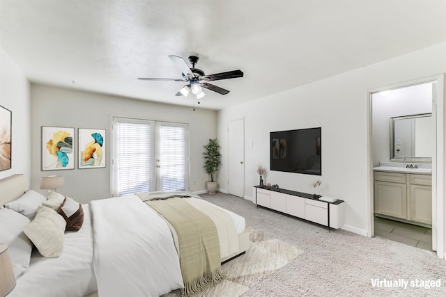 carpeted bedroom featuring ensuite bathroom, ceiling fan, and sink