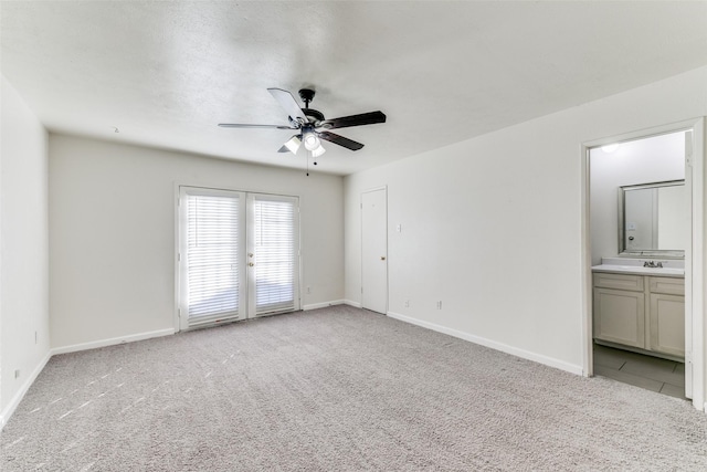 unfurnished room featuring light carpet, ceiling fan, and sink