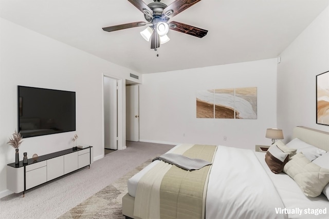 bedroom with ceiling fan and light carpet