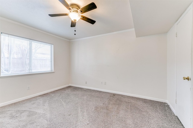 empty room with ceiling fan, light colored carpet, and ornamental molding