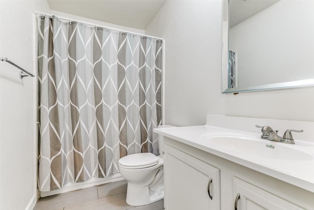 bathroom featuring vanity, toilet, and walk in shower