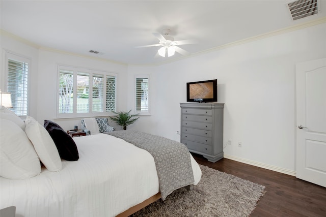 bedroom featuring ceiling fan, crown molding, and dark hardwood / wood-style floors