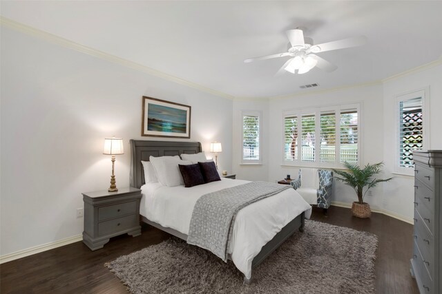 bedroom with ceiling fan, dark wood-type flooring, and ornamental molding