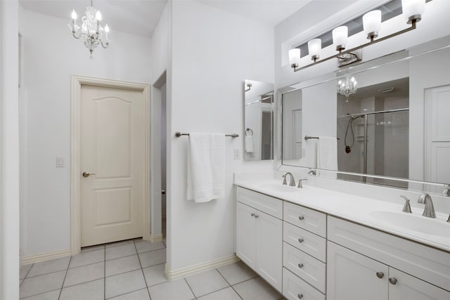 bathroom with tile patterned flooring, vanity, a chandelier, and an enclosed shower