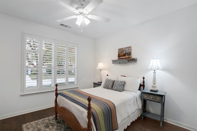 bedroom featuring multiple windows, ceiling fan, and dark hardwood / wood-style floors