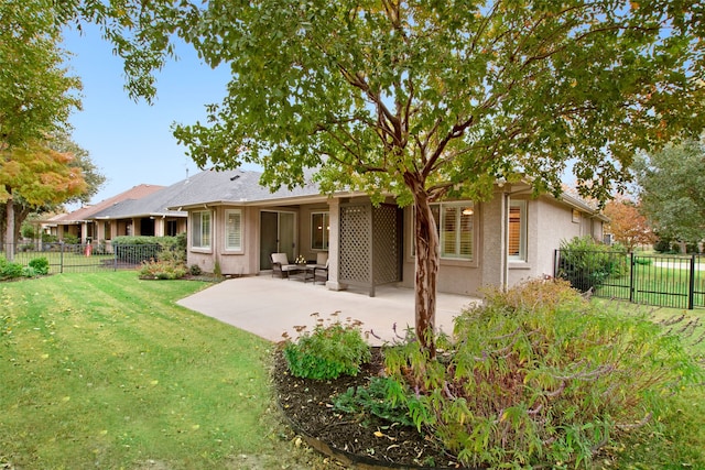 back of property featuring a lawn and a patio