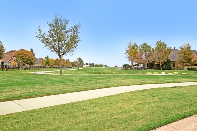 view of property's community with a lawn