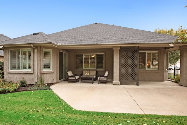 rear view of property with a yard and a patio