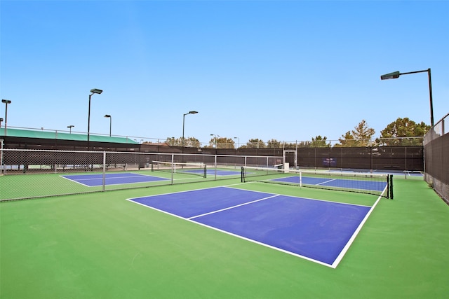 view of tennis court with basketball hoop