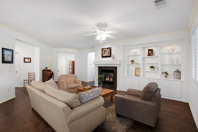 living room with ceiling fan, dark hardwood / wood-style flooring, built in features, and ornamental molding