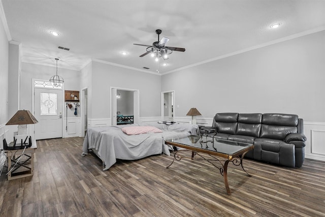 living room with dark hardwood / wood-style floors, ceiling fan, and ornamental molding