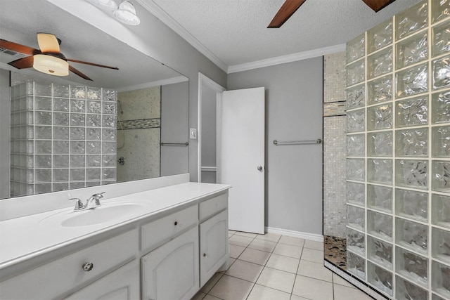 bathroom featuring tile patterned floors, ornamental molding, vanity, a textured ceiling, and a shower