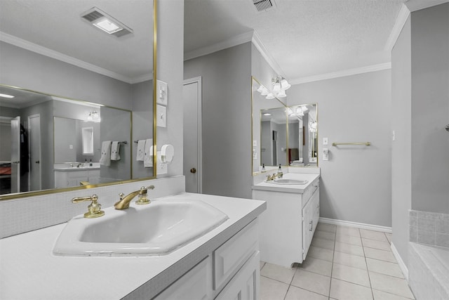 bathroom featuring tile patterned floors, vanity, ornamental molding, and a textured ceiling