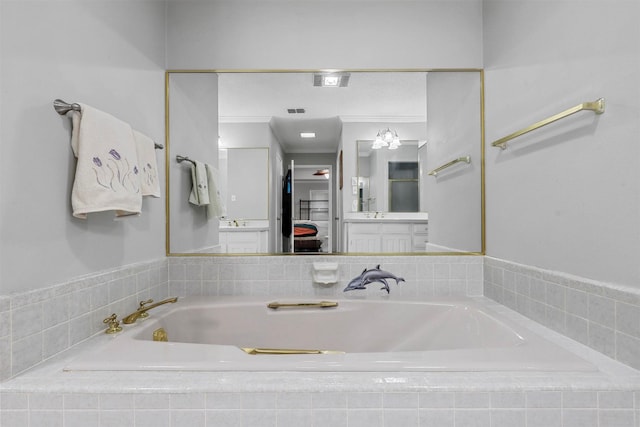 bathroom featuring vanity, a relaxing tiled tub, and ornamental molding