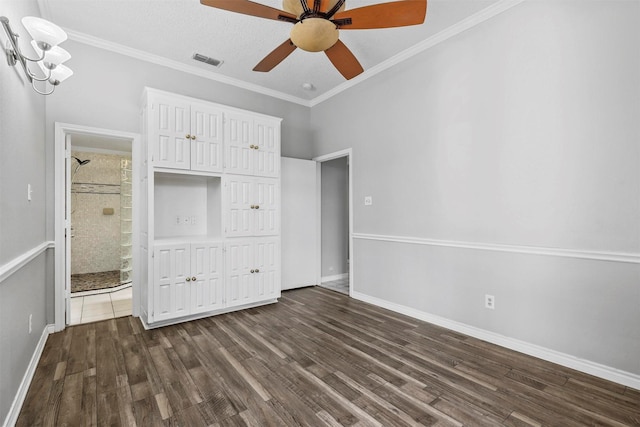 unfurnished bedroom with ceiling fan with notable chandelier, ornamental molding, a textured ceiling, connected bathroom, and dark hardwood / wood-style flooring