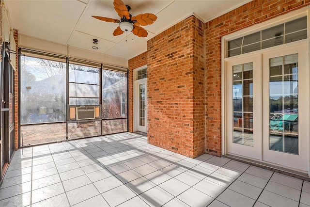 unfurnished sunroom with ceiling fan and cooling unit