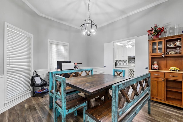 dining area featuring ceiling fan with notable chandelier, dark hardwood / wood-style flooring, and ornamental molding