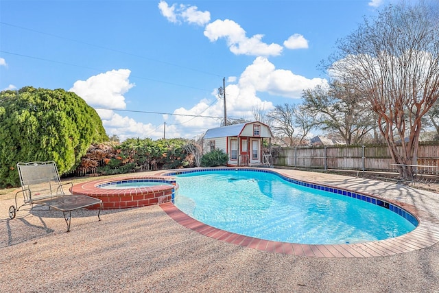 view of pool with an in ground hot tub