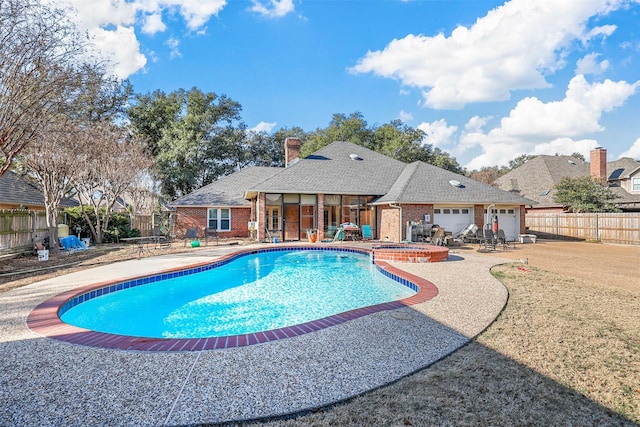 view of pool featuring an in ground hot tub and a patio