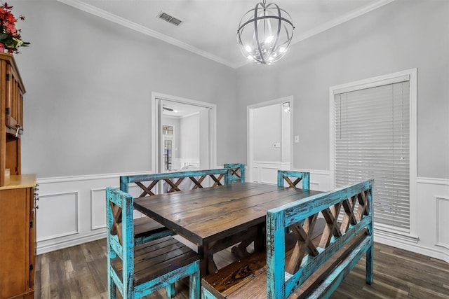 dining area with crown molding, dark hardwood / wood-style floors, and an inviting chandelier