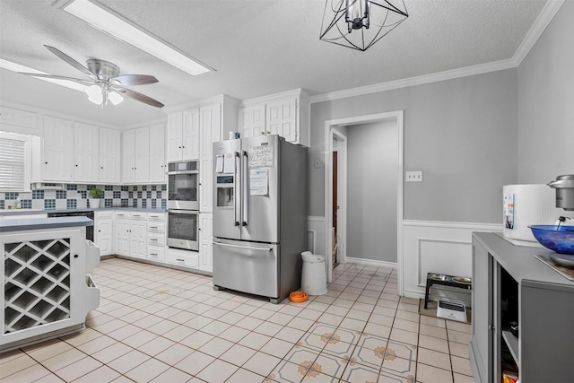 kitchen with white cabinetry, ceiling fan, stainless steel appliances, and a textured ceiling