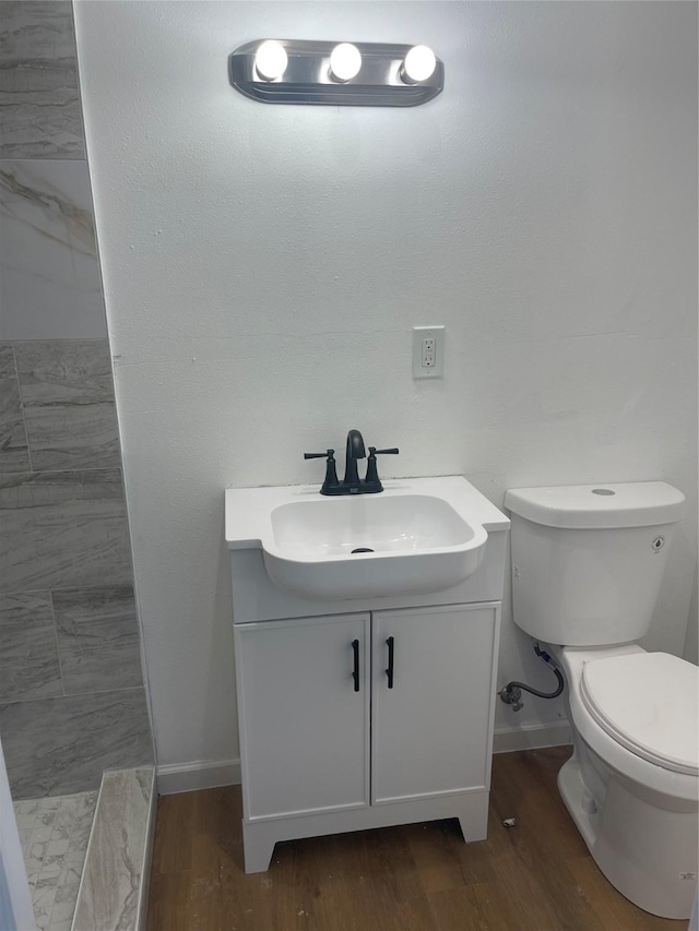 bathroom featuring hardwood / wood-style floors, vanity, and toilet