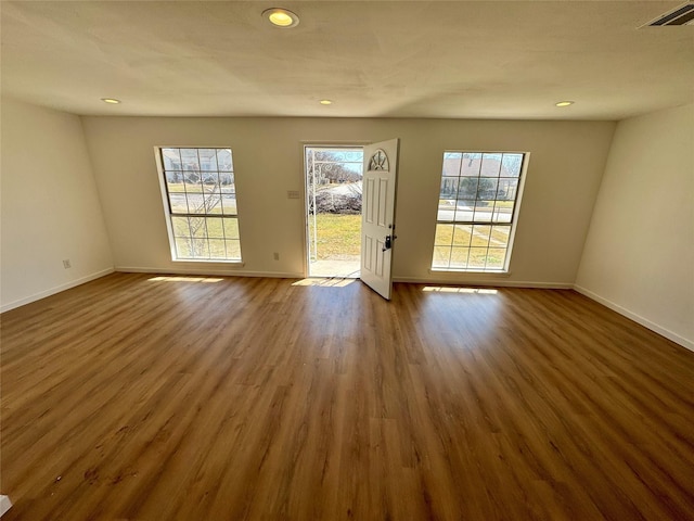 interior space with dark wood-style floors, a wealth of natural light, visible vents, and recessed lighting