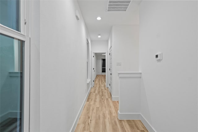 hallway with light hardwood / wood-style floors