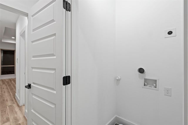 clothes washing area featuring gas dryer hookup, hookup for a washing machine, light wood-type flooring, and hookup for an electric dryer