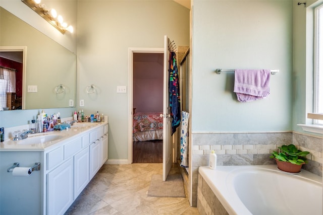 bathroom featuring vanity and a relaxing tiled tub