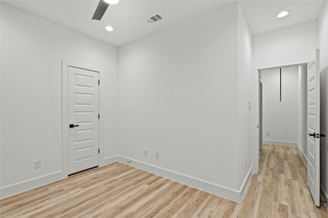 empty room featuring ceiling fan and light hardwood / wood-style floors