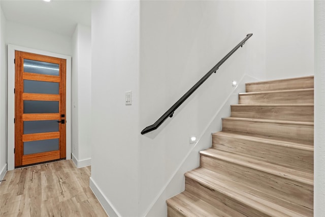 stairs with hardwood / wood-style floors